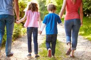 Rear View Of Family Walking In Countryside