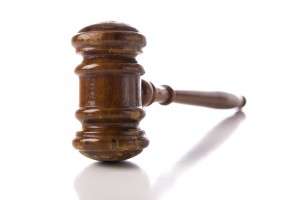 A judges wooden gavel on a white background